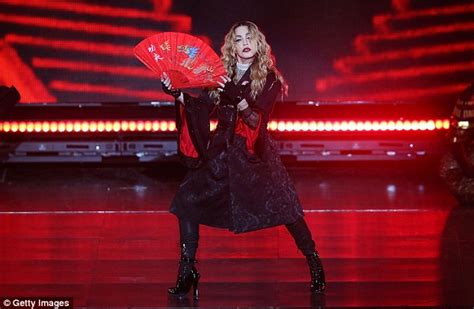 madonna pulls down a female fan s top and exposes her bare breast in