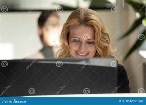 middle aged female employee work on pc at workplace stock image image