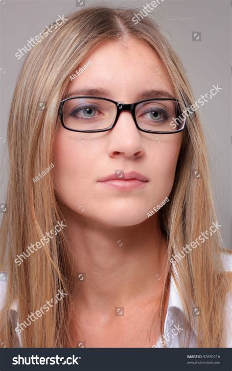 Portrait Of A Woman In Glasses Blonde Closeup On Gray