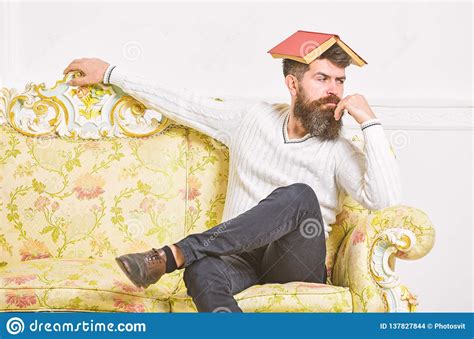 macho sits with open book on head like roof boring literature concept guy bored fed up of