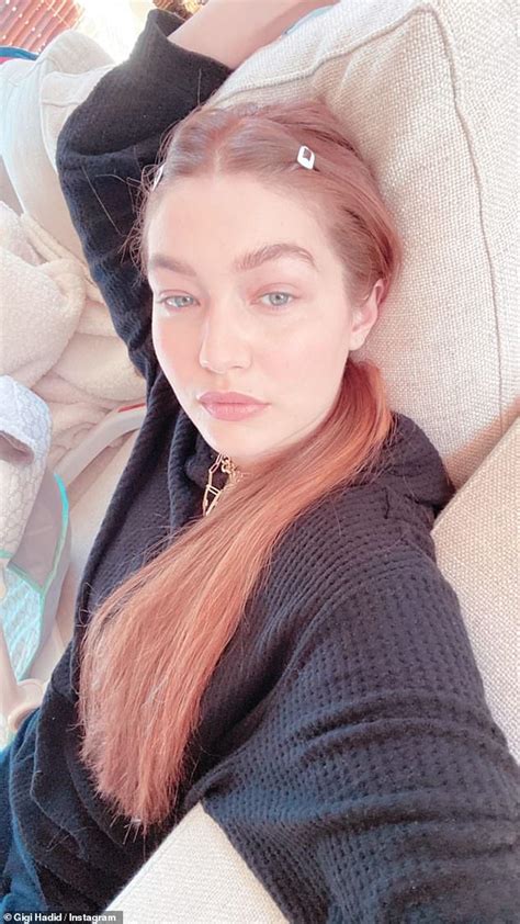 gigi hadid pairs newly colored red hair with blue plaid coat as she