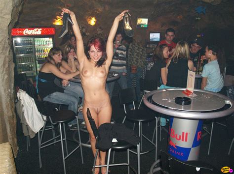 naughty redhaired slut takes everything off including her shoes in a bar