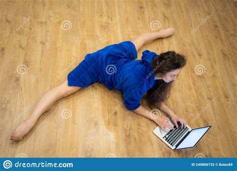Very Flexible Woman Exercising At Home In Front Of Her Laptop
