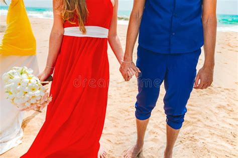 A Picture Of A Happy Couple Holding Hands At The Beach Newlyweds At