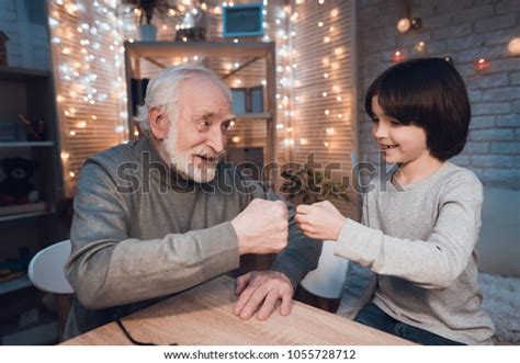 grandfather grandson playing rock paper scissors stock