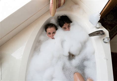 overhead photo of a mother and her teenager daughter in the bathtub