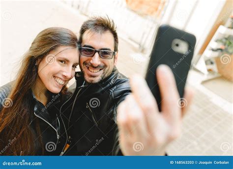 Young Couple In Love Making A Selfie On The Street Posing As Amateur