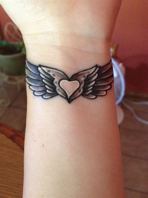angel wing tattoo   heart   middle wing tattoos  wrist