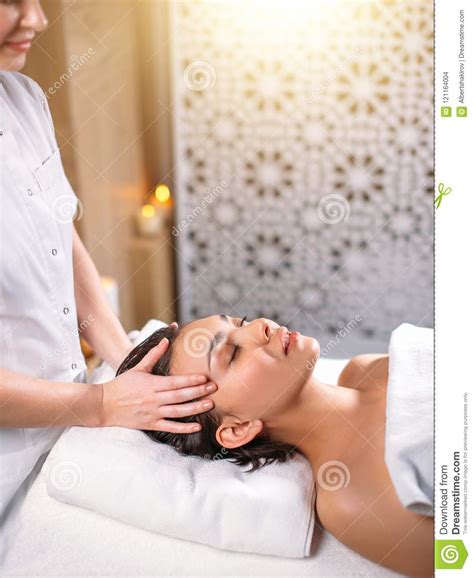 Good Looking Girl With Closed Eyes Getting Head Massage In The Spa