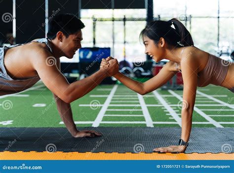 Healthy Smiling Couple Of Man And Woman Giving High Five To Each Other