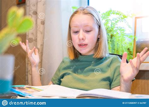 One Sad Girl Sitting And Holding Her Head In Her Hands Stock Image