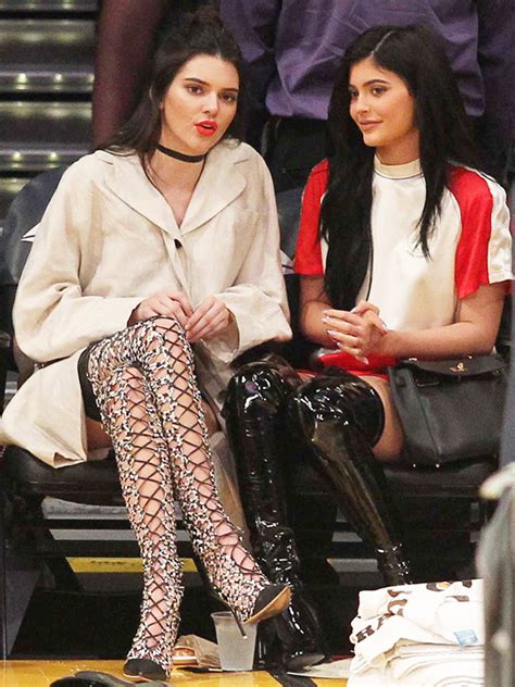 kendall and kylie jenner s thigh high boots at lakers game