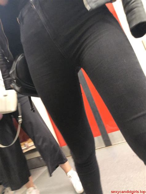 hot ass and legs in black tight jeans in the subway train