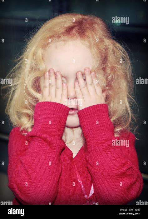 girl hiding face hands  res stock photography  images alamy