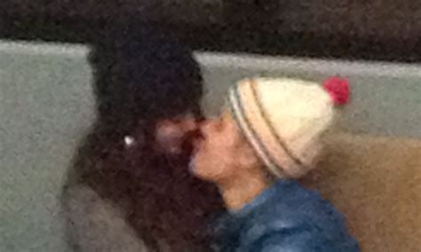 selena gomez sits on justin bieber s lap as they kiss in airport after romantic ski break
