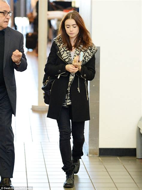 Lily Collins Makes An Unsmiling Departure Clutching Her Passport As