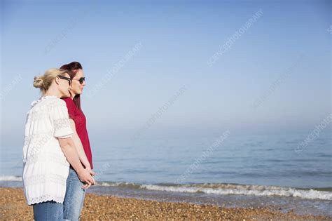 Lesbian Couple Holding Hands On Ocean Beach Stock Image F023 0090