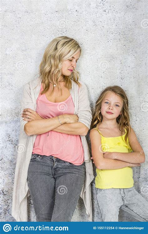 Pretty Blonde Young Mother Poses And Cuddles With Her Daughter In