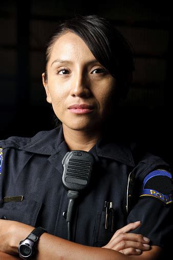an uniformed female police officer with her arms folded