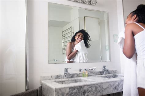 Beautiful Black Woman Drying Her Face With A Towel While Looking At