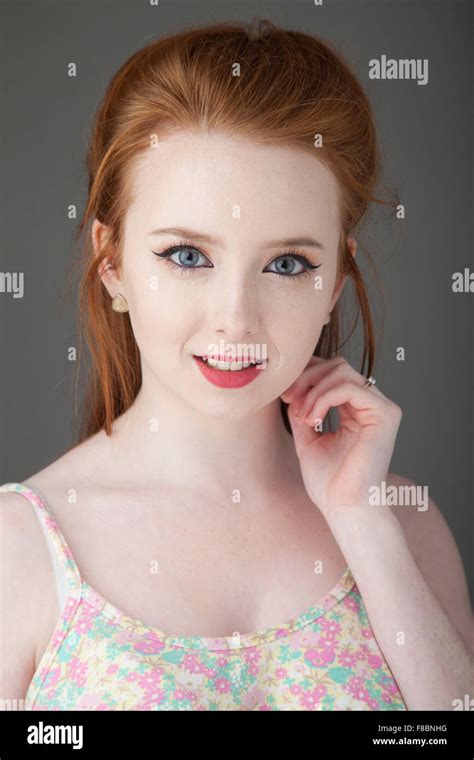 pretty redheaded woman with pale skin looking towards camera stock
