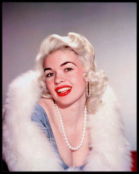 a woman wearing pearls and a fur collar