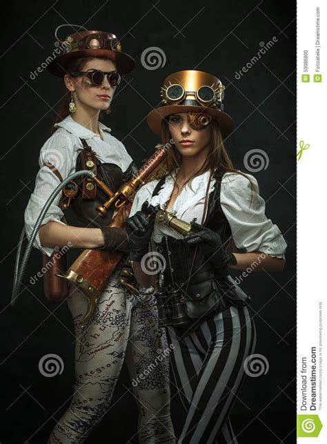 two girls dressed in the style of steampunk with arms