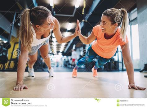 Two Sporty Girls Doing Push Ups In Gym Stock Image Image Of Exercise