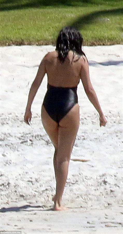 selena gomez displays her sensational curves in a sexy plunging swimsuit as she cools off in the