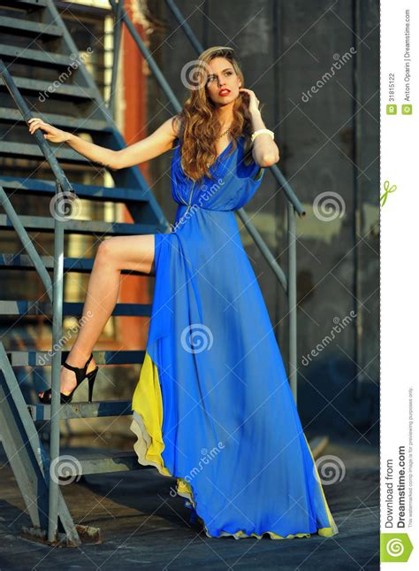 fashion model posing sexy wearing long blue evening dress