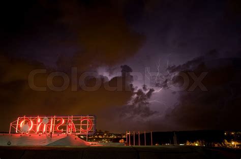 casnio neon sign  ominous sky clouds  lightning stock image