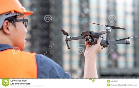 young asian engineer holding drone  construction site stock image image  pilot monitoring