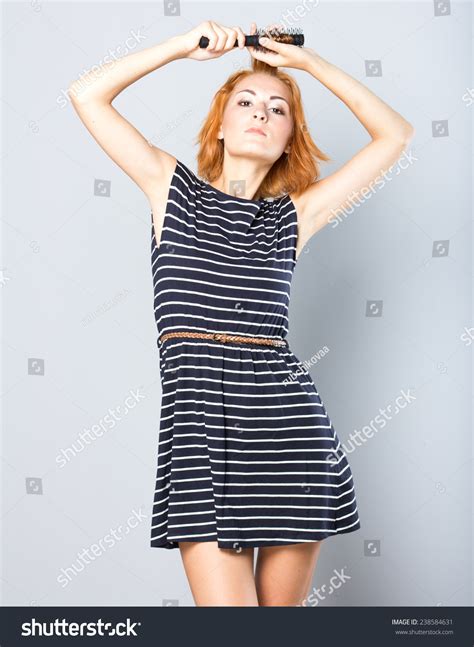 skinny redhead girl brushing her hair woman hair style