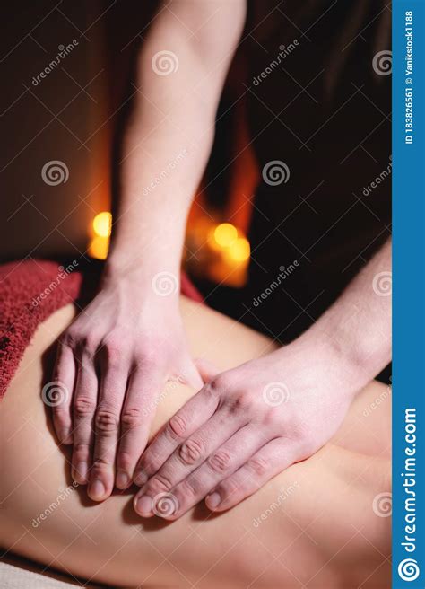 close up male hands of a professional massage therapist make