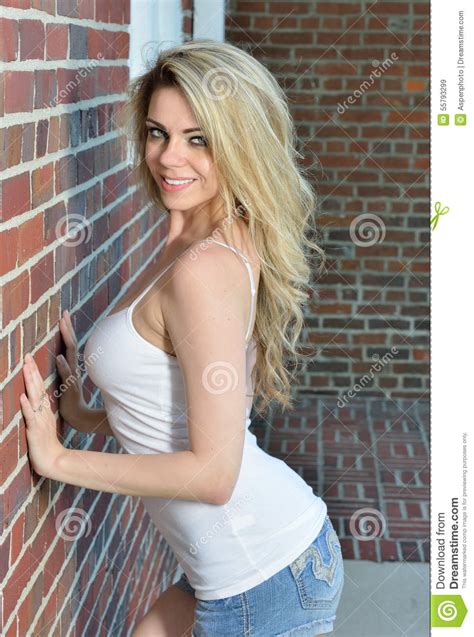 Blonde Woman In White Tank Top And Denim Stock Image