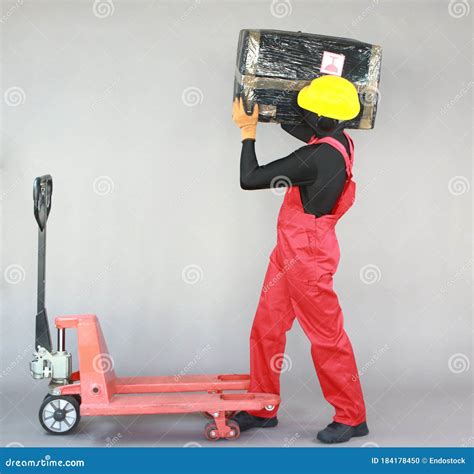anonymous worker carrying heavy package profile view stock photo image  industrial