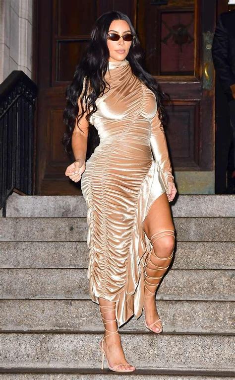 reality star kim kardashian glows in a gold ruched bodycon