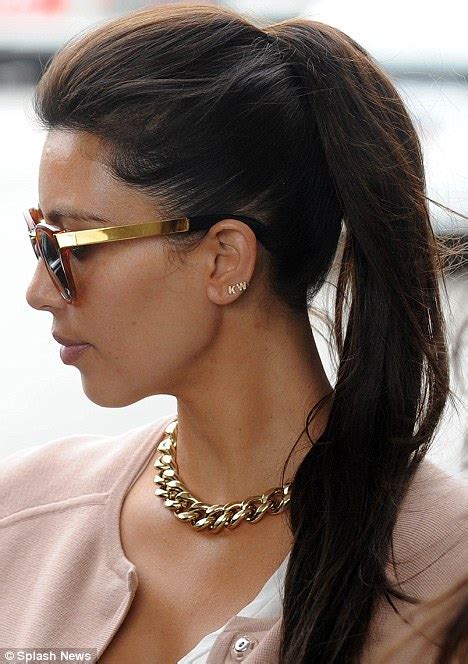 Kim Kardashian Flaunts Gold Earrings In The Shape Of Kanye Wests