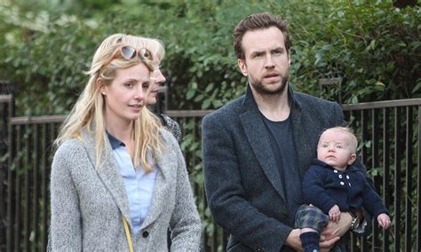 rafe spall shows he s a hands on dad as he cradles his