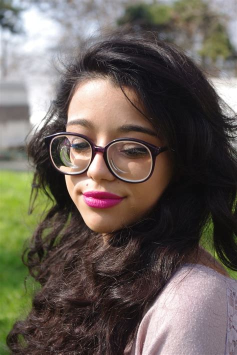 stunning raven haired girl with long hair wearing big round glasses