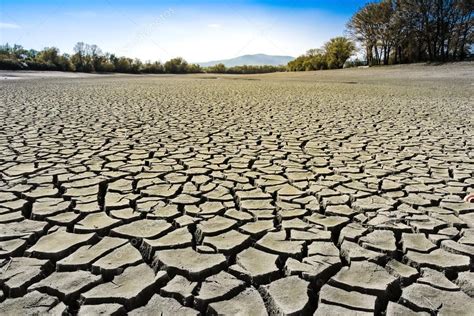 dry cracked earth dried  bottom   pond stock photo