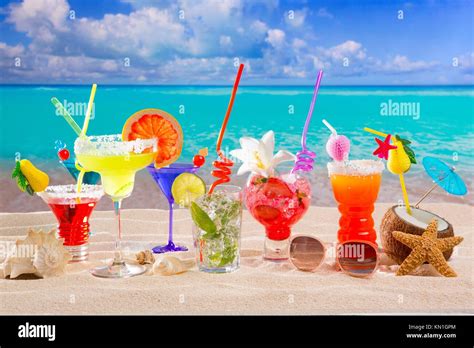 Colorful Tropical Cocktails At Beach On White Sand And Turquoise Water