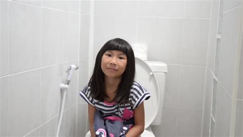 asian girl using toilet at stock footage video 100 royalty free 1007893990 shutterstock