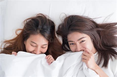 Asia Lesbian Lgbt Couple Lay On Bed Cover With Blanket And Smile With