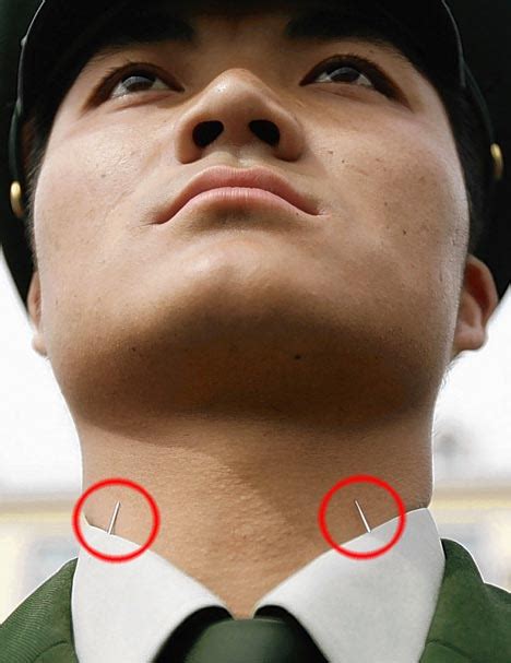 pictured how china gets its troops to stand to attention pins in