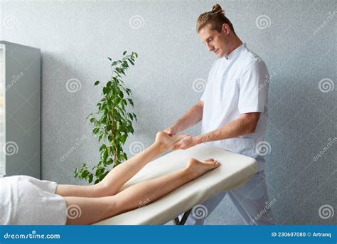 masseur massages  feet   young woman healing body massage