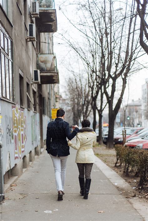 Couple Walking Down The Street By Stocksy Contributor Boris