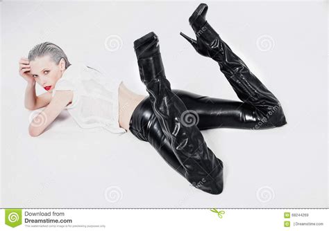Girl In Black Leggings Lying On A White Background Stock