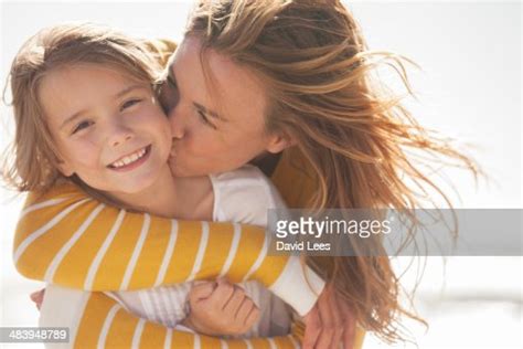 Close Up Of Mother Kissing Daughter At Beach Photo Getty Images