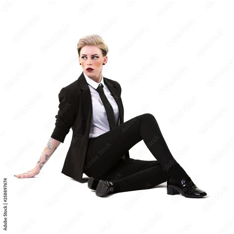 Short Haired Blonde Woman Sitting On The Floor Wearing A Suit Shirt